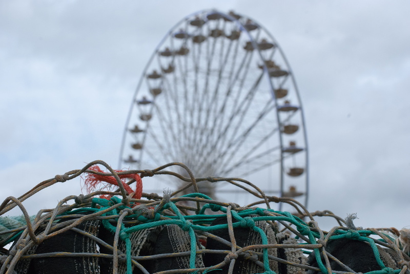 arts culture and entertainment, water, circle, geometric shape, wheel, sky, nature, net, amusement park, shape, day, cloud - sky, fishing industry, rope