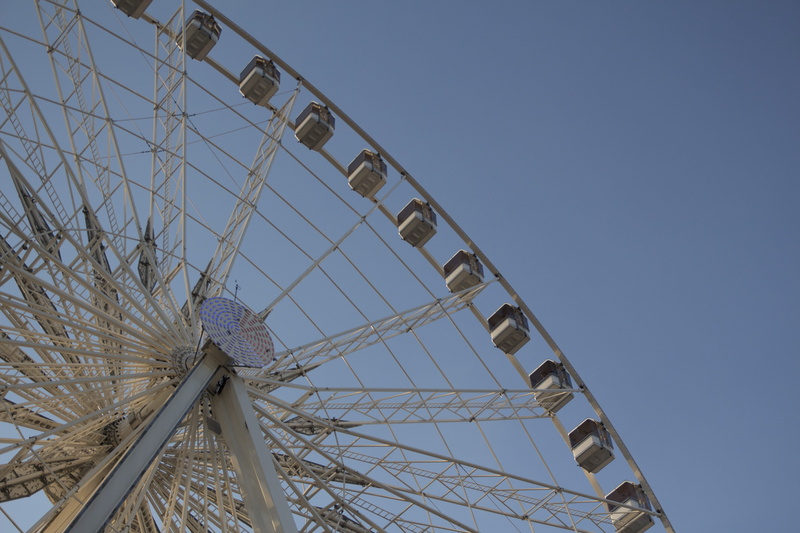 hang, france, clear sky, built structure, blue sky, ferris wheel, outdoors, low angle view, paris, sun, afternoon, large, architecture, shape, arts culture and entertainment