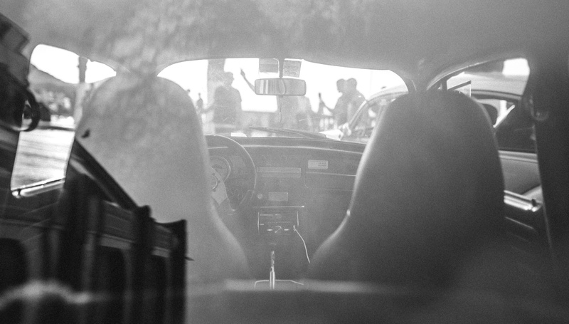 adult, urban, sitting, land vehicle, mode of transportation, glass - material, independenceday, travel, outdoors, men, rear view, car interior, motor vehicle
