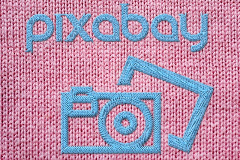 communication, full frame, hand labor, design, fabric, pink color, message, woven, textile, art, blue, pattern, embroidery, art and craft, thread, close-up