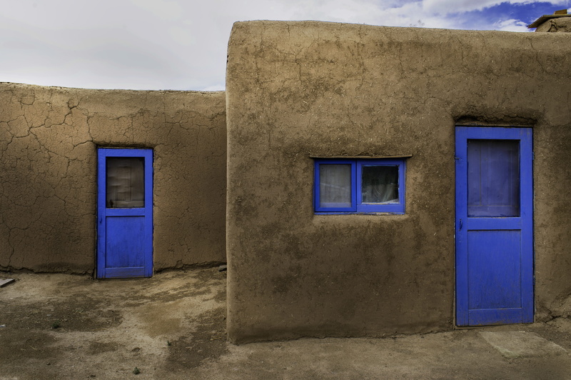 wall - building feature, doors, blue, day, building exterior, cloud - sky, old, sky, purple, no people, empty, building, taos pueblo, dwelling, architecture