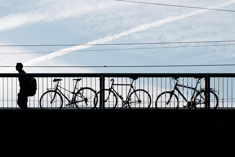 black, cloud - sky, bikes, bike, man, bicycle, pedal bike, full length, cycle, nature, sky, locked bike, cable, city, person, beside, real people, railing