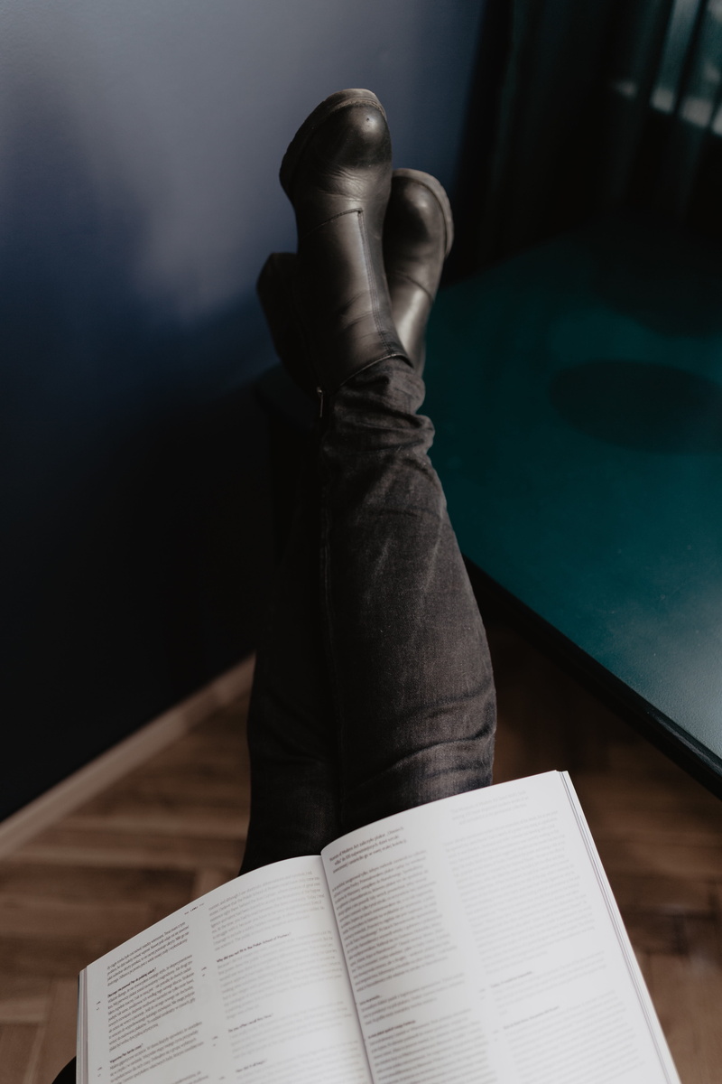 rose, boots, leisure activity, holding, paper, real people, break, trousers, human foot, relaxation, table, body part, studying, education, high angle view