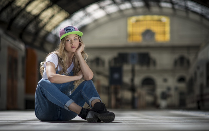 flap trousers, white shirt, train station, women, baseball caps, blonde, sitting, looking at viewer, 1080P, jeans, overalls