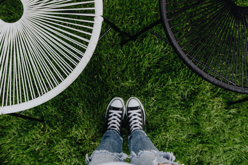 sneakers, nature, girl, real people, human foot, garden, personal perspective, concrete, legs, grass, lifestyles, jeans, low section, outdoors, shoe, green