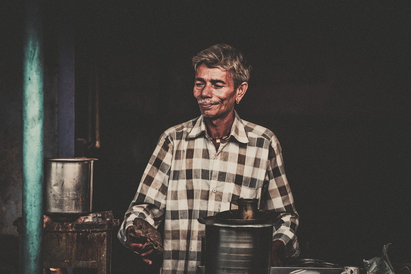 shirt, bottle, musical instrument, pub, cooker, looking at camera, apparel, musician, men, food and drink, man, smiling, electronics, mid adult men, mature men