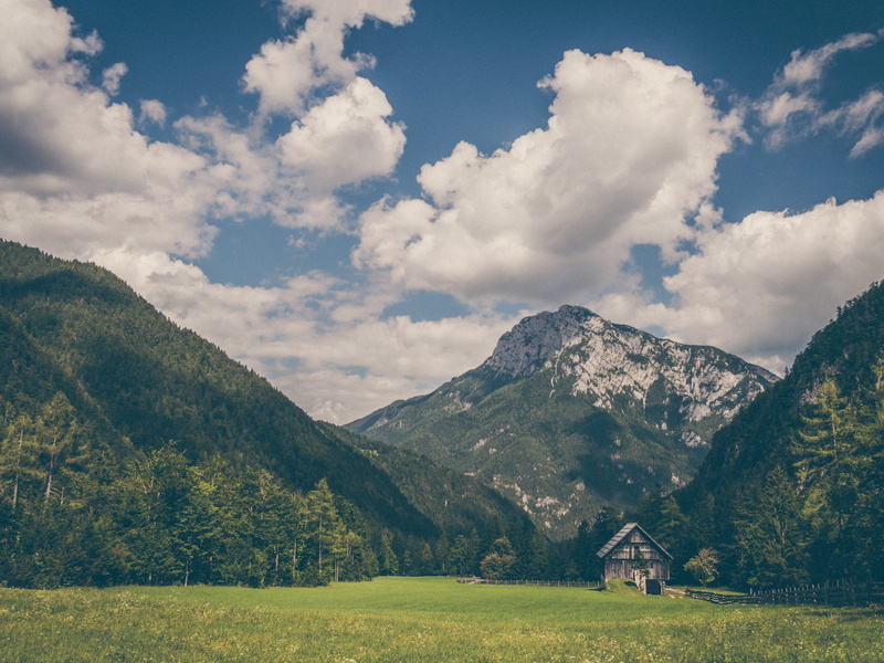 tranquil scene, architecture, sky, cloud, land, grass, cloud - sky, environment, forest, house, hill, alp, day, beauty in nature, plant, peak, mountain peak