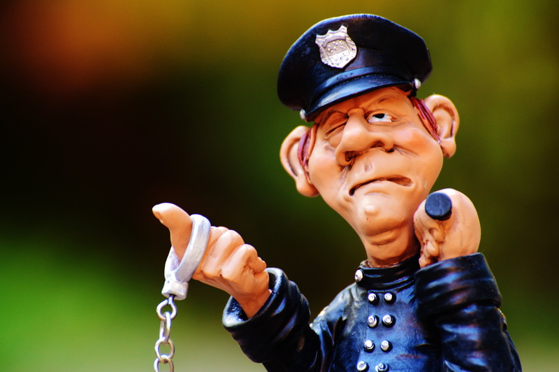 outdoors, cap, males, baton, cop, looking, funny, headshot, waist up, uniform, looking at camera, adult, child, clothing, people, boys, holding, police