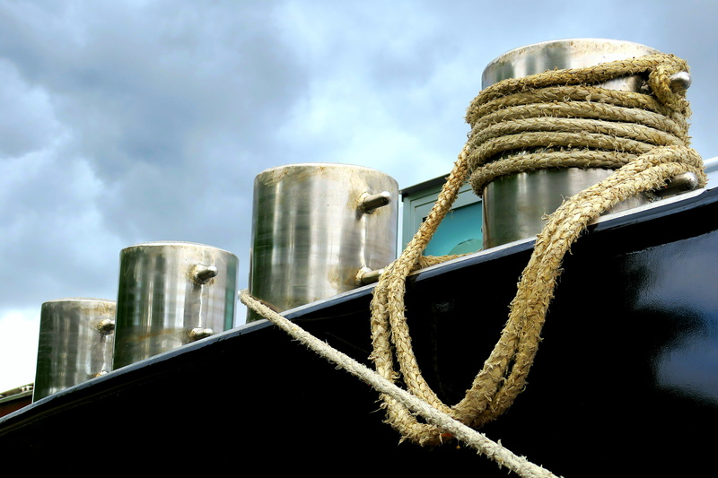 rigging, low angle view, bollard, canvas, factory, mooring, architecture, equipment, barge, storm clouds, nautical vessel, day, sky, metal, cordage, water
