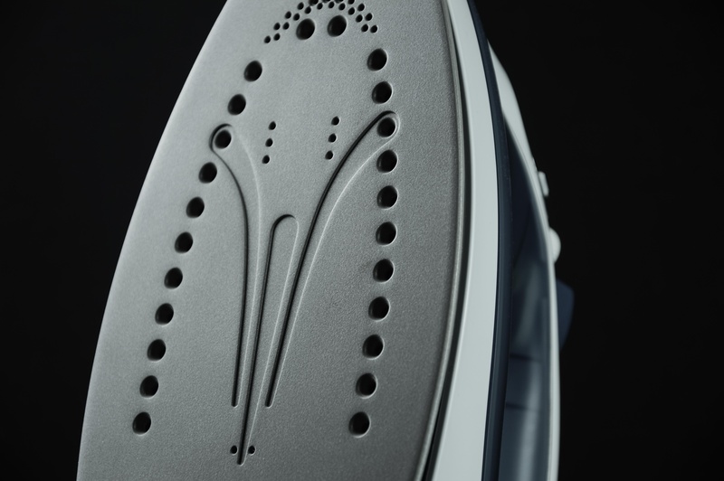 technology, still life, ironing, studio shot, spotted, steel, white, iron, clothes, housework, electric, closeup, hole, copy space, indoors, silver colored