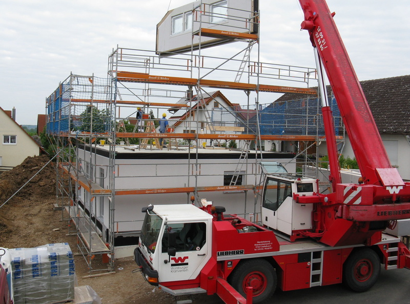 outdoors, construction workers, sky, day, new building, mode of transportation, lifting, red, crane, work, home, construction site, single family home