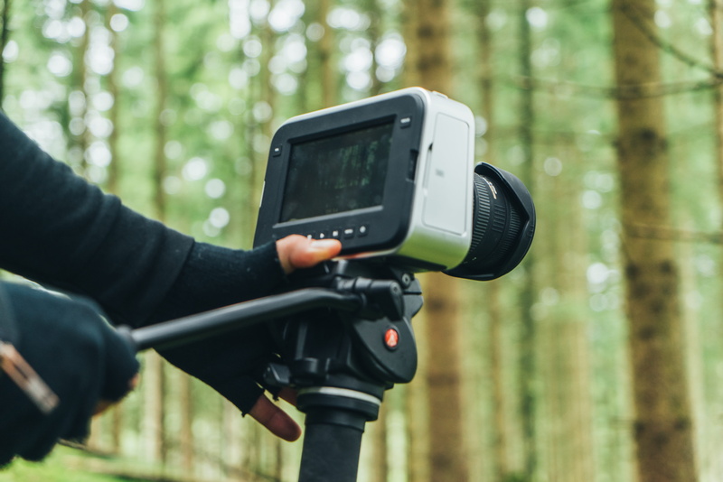 hand, face, video making, tree, forest, technology, black, wireless technology, human, camera man, outdoors, video maker, activity, vegetation, person