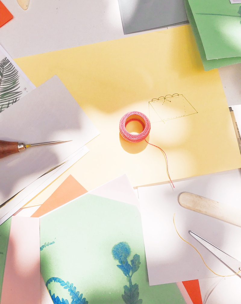 graphics, greeting card, paintbrush, scroll, communication, day, airmail, goblet, directly above, origami, pencil, high angle view, glass, western script