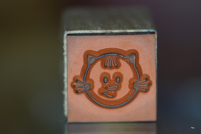 day, close-up, face, no people, wood - material, selective focus, 5K, stamp, shape, brown, wood stamp, anthropomorphic, craft, child, smiling, indoors