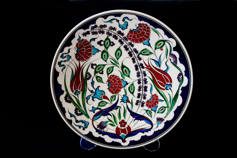 studio shot, indoors, ornate, black background, close-up, handicrafts, circle, design, ceramics, art and craft, atalay melahat glow, floral pattern, ceramic