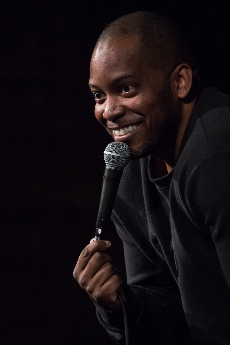 funny, front view, comic, performer, black, 160, headshot, one man only, men, studio shot, people, comedy, smile, waist up, young adult, black background