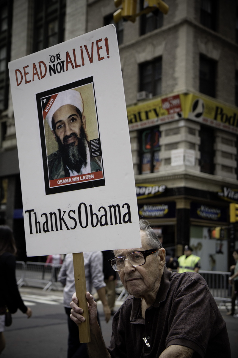 alive, real people, male likeness, built structure, obama, men, osama, man, incidental people, urban, poster, focus on foreground, text, building exterior