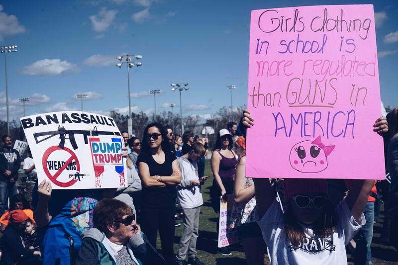 woman, holding, protest, lifestyles, banner - sign, sky, clear, t, real people, adult, wearing, posters, march, shirt, placard, group of people, text, message