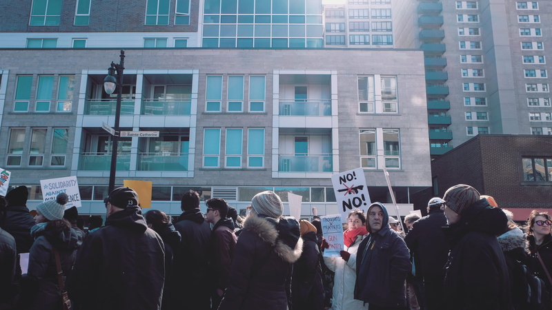 built structure, window, text, real people, 2K, city life, gathered, adult, crowd, office building exterior, protestor, standing, building exterior, communication