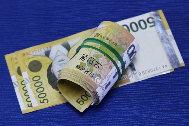 blue background, a wad of money, don, financial, metal, finance, bank, text, close-up, property, indoors, money, shares, cash, paper currency, still life