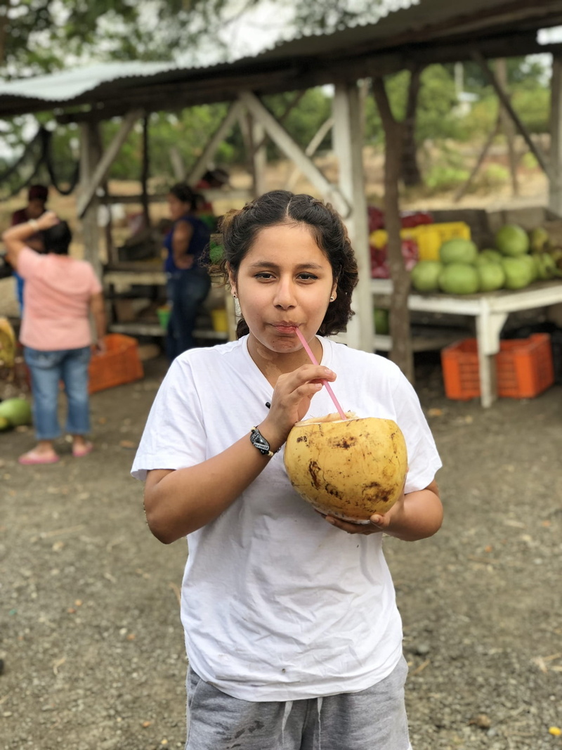 standing, men, looking at camera, market, smile, 1080P, holding, portrait, person, coconut, front view, girl, woman, fruit, real people, healthy eating