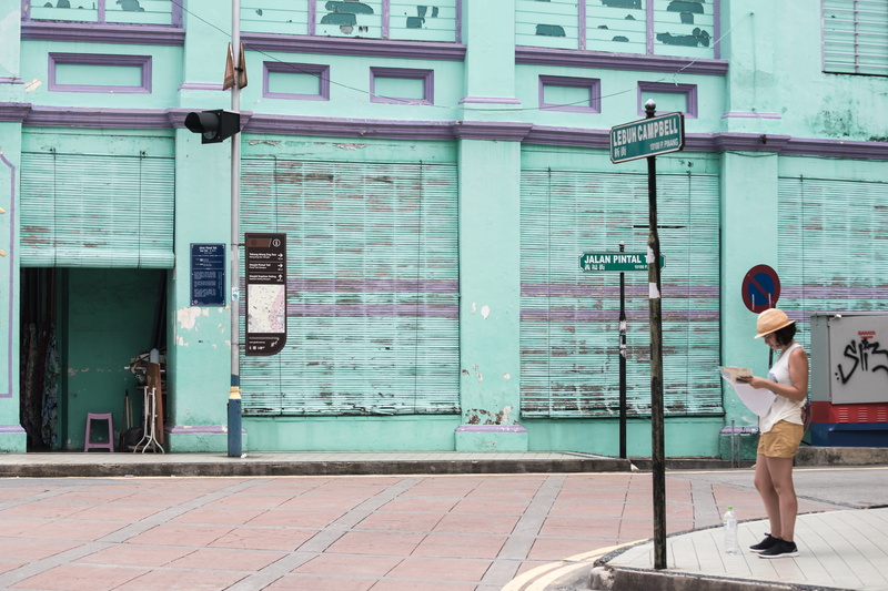 architecture, casual clothing, pole, street, real people, full length, building exterior, leisure activity, outdoors, side view, entrance, 5K, city, signage