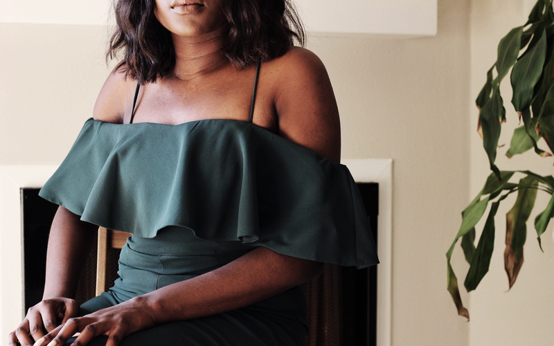 young adult, smile, dress, lifestyles, clothing, casual clothing, sitting, fashion, lap, waiting, girl, black girl, arm, african american, hand, looking
