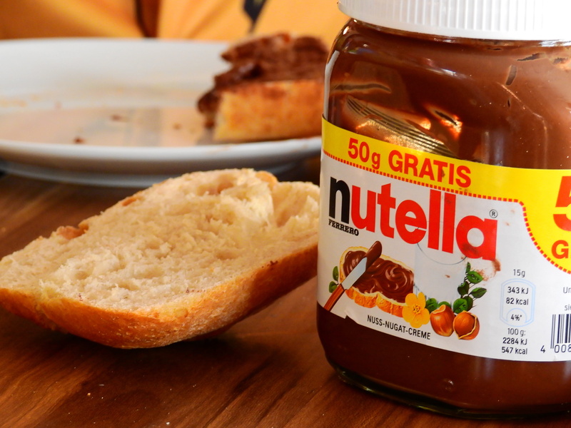 children, nutella, sugar, drink, bread, table, indoors, meal, delicious, refreshment, text, ready-to-eat, food and drink, wood - material, western script
