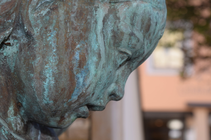 outdoors, damaged, close-up, obsolete, patina, head, rusty, figure, profile, focus on foreground, metal, architecture, old, bronze statue, run-down, deterioration