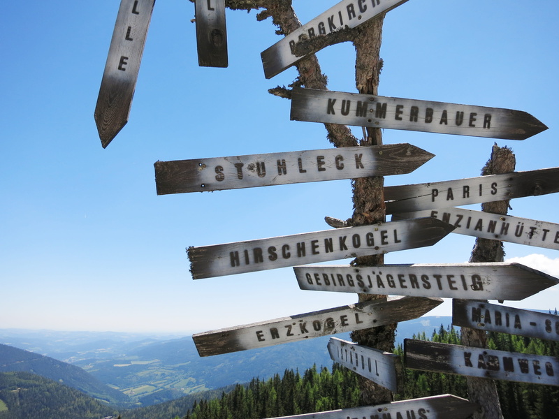 sunlight, built structure, guidance, next, marking, city, person, signpost, architecture, sky, mountain, low angle view, showing, arrow, clear sky, outdoors