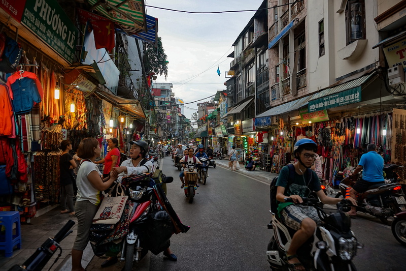 busy street, large group of people, city life, scooters, explore, group of people, men, women, hanoi, street, choas, architecture, mode of transportation