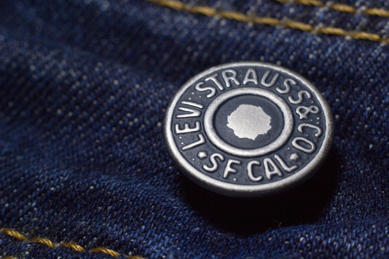 text, military, design, levi strauss, 5K, shape, close-up, blue, single object, indoors, texture, western script, pants, patriotism, government, clothing