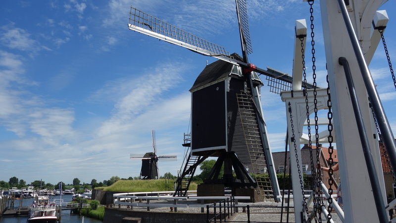 architecture, no people, village, outdoors, 5K, skyscraper, turbine, low angle view, building exterior, historic mill, cloud - sky, traditional windmill