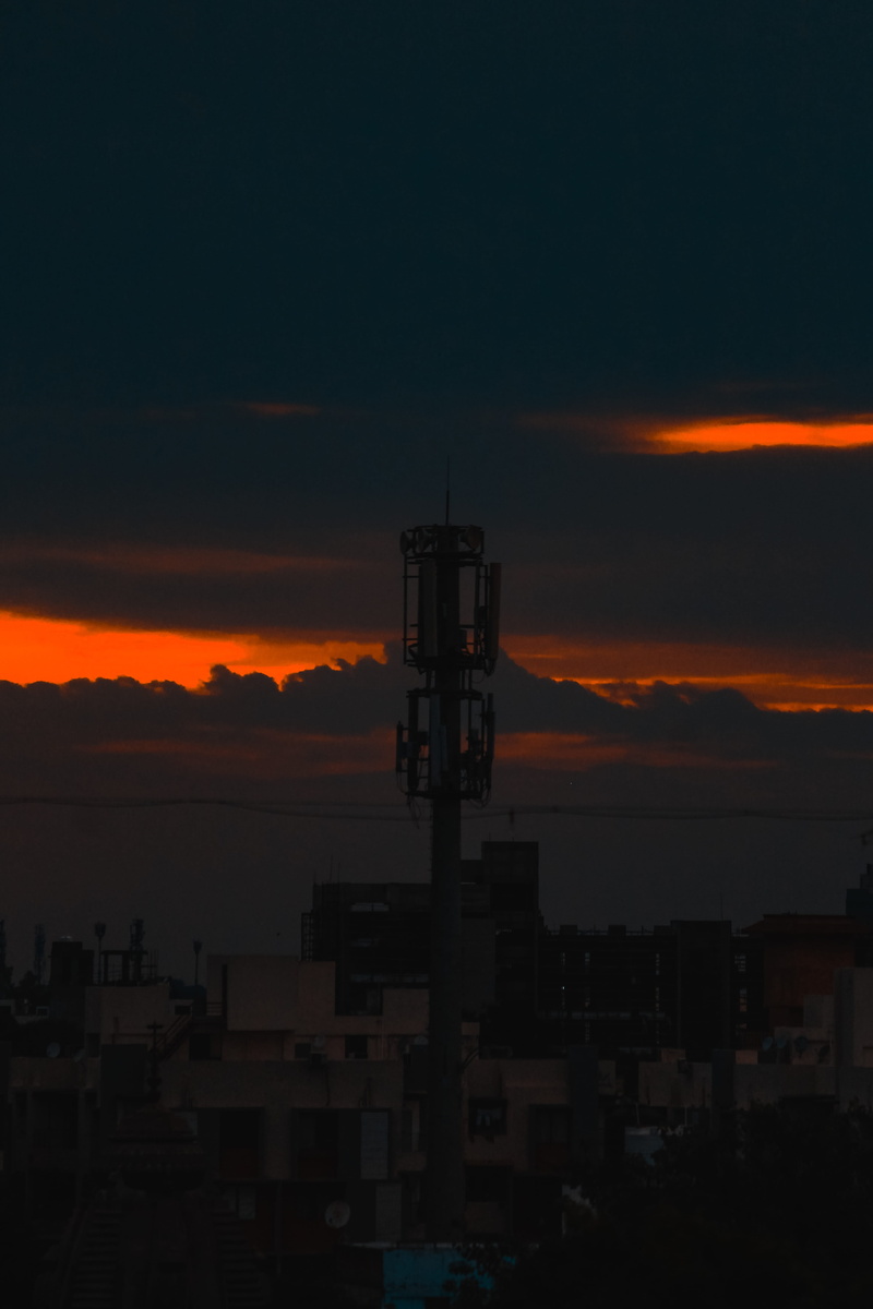 no people, orange color, silhouette, india, outdoors, building exterior, technology, sunset, ahmedabad, nature, thaltej, sky, building, city, tall - high