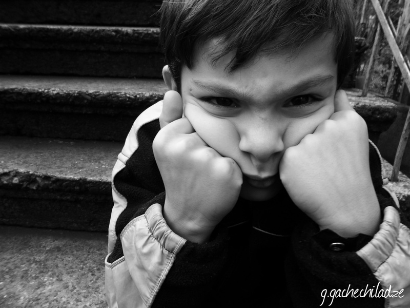 one person, boy, leisure activity, track, men, headshot, sitting, innocence, s, real people, jacket, looking at camera, portrait, hand, boys, 2K, monochrome