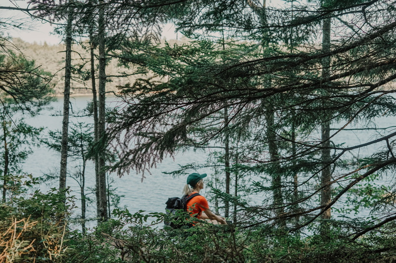 casual clothing, day, coat, girl, one person, vegetation, men, leisure activity, backpack, sitting, nature, beauty in nature, monk, body, daytime, human