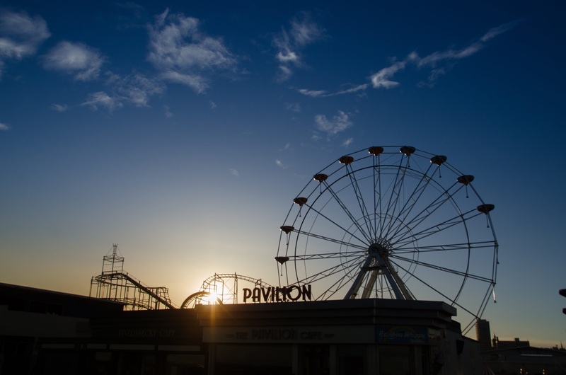 low angle view, attraction, construction, sky, fun, fair, building exterior, fairground, ferris wheel, amusement park, pleasure, sunset, colorful, carousel