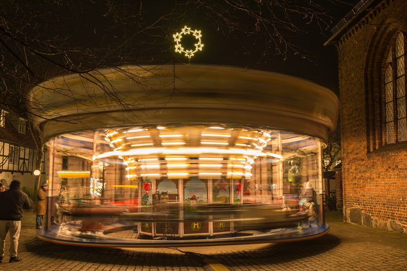 speed, arts culture and entertainment, drive, night, architecture, evening, auto, wooden horse, building exterior, motion, christmas market, urban Scene