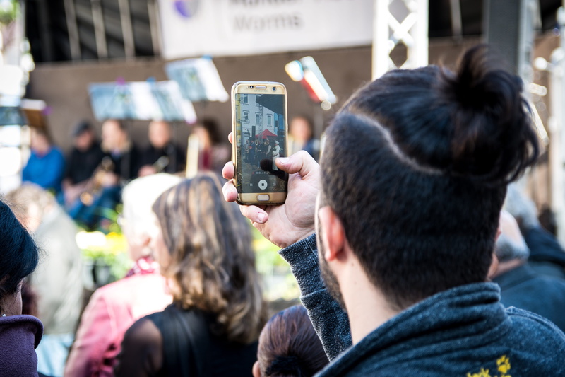 event, smart phone, technology, outdoors, focus on foreground, adult, men, crowd, festival, mobile phone, celebrate, wireless technology, activity, communication