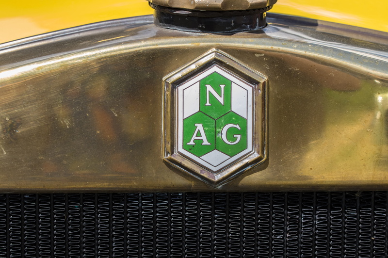 automotive, western script, wall - building feature, transportation, direction, green color, human representation, illuminated, classic, sign, outdoors