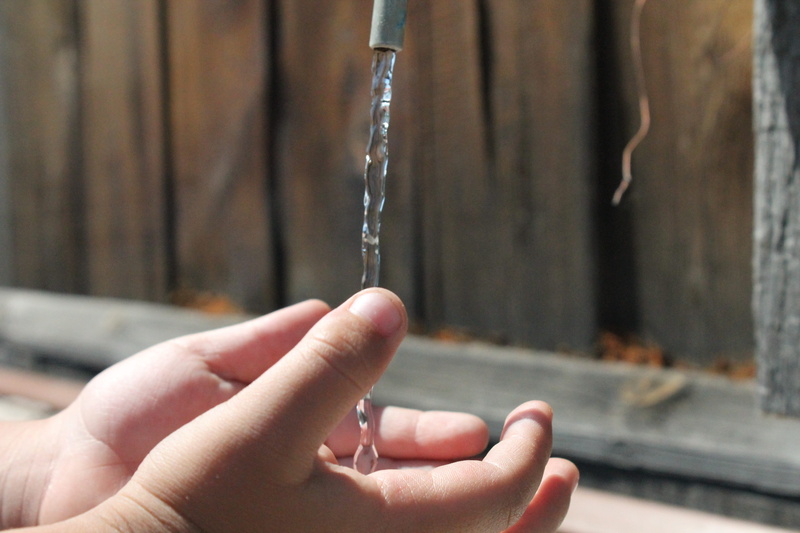 real people, running water, body part, human body part, water, close-up, focus on foreground, 4K, one person, Childhood, kids, holding, metal, motion