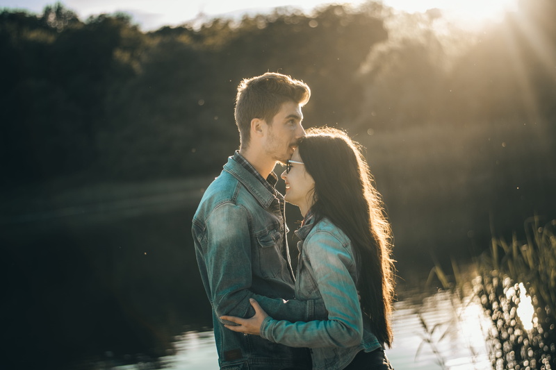 real people, kissing, outdoors, young men, lake, lifestyles, men, lens flare, nature, togetherness, heterosexual couple, bonding, front, young adult, man