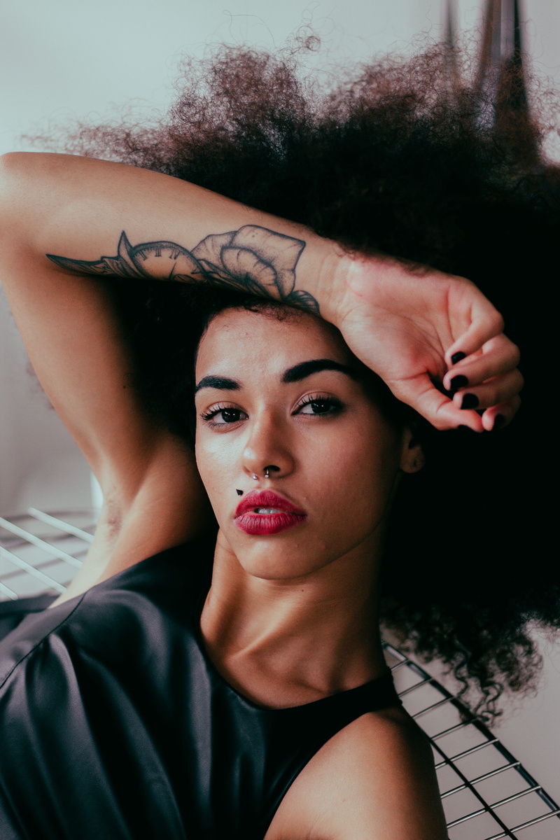 real people, lipstick, headshot, curly hair, beautiful woman, make-up, looking at camera, brunette, woman, front view, photo, resting, adult, tattooed