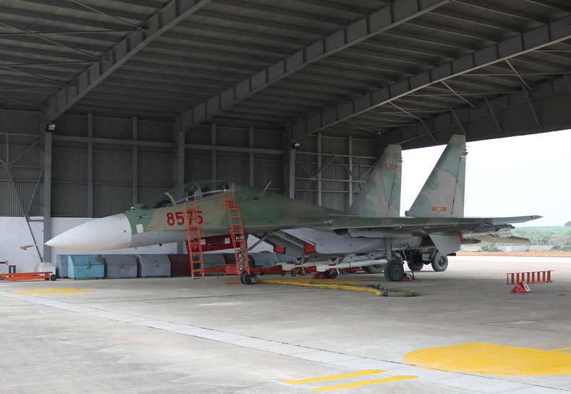 the airfield, public transportation, airport runway, air vehicle, hangar, outdoors, airport, industry, bridge - man made structure, airplane, Su-30, aircraft