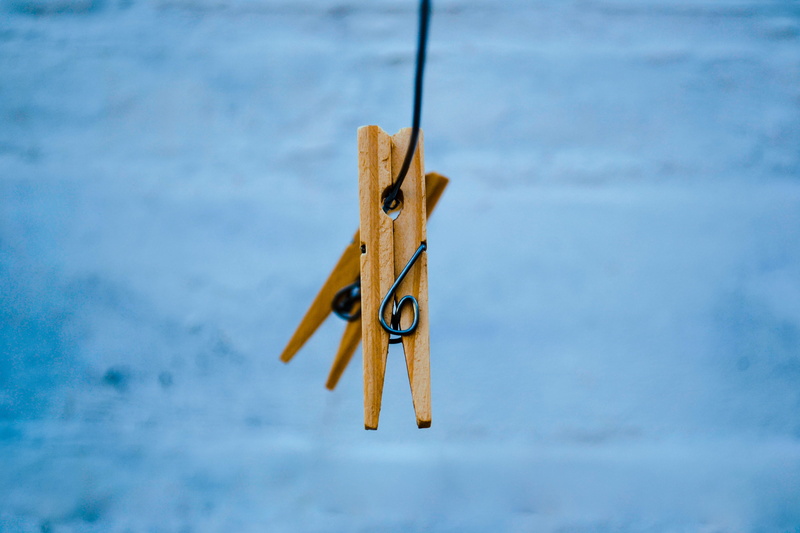clothes, clip, outdoors, nature, equipment, still life, brown, focus on foreground, no people, rope, wood - material, clothespin, tie, pegs, blue, metal