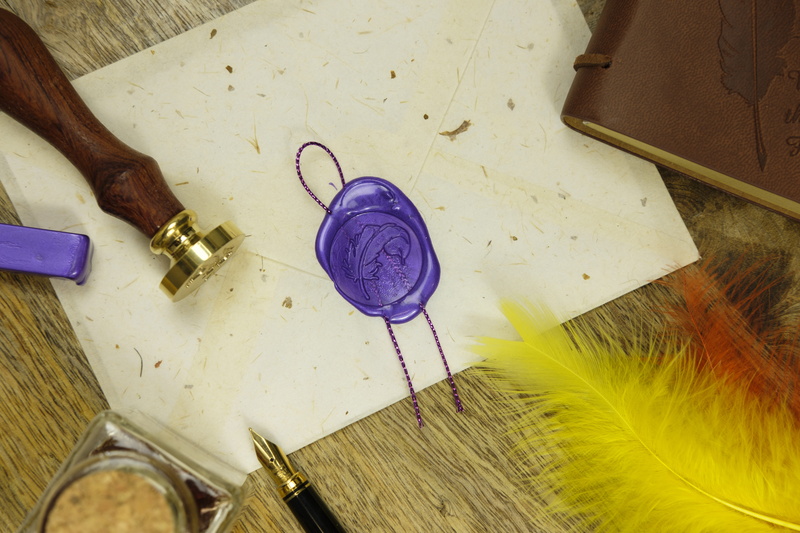 message, still life, textile, stamp, equipment, wood - material, writing implement, creativity, indoors, communication, purple, personal accessory, envelope