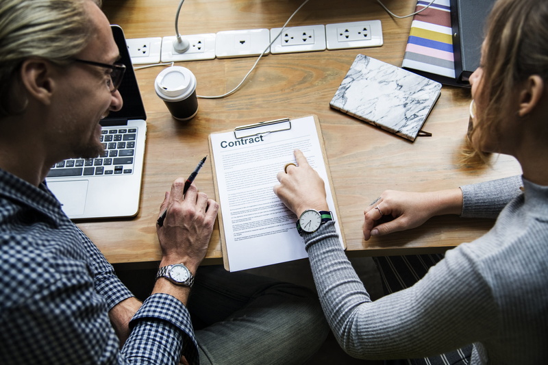indoors, sitting, signature, workplace, together, two people, woman, adult, agreement, discussion, talking, teamwork, paper, contract, pen, beside, entrepreneur