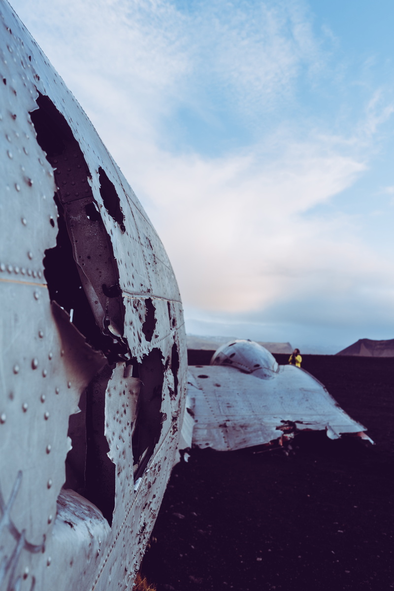 mode of transportation, transportation, bokeh, wheel, metal, 8K, outdoors, rust, person, hole, wrecked, light, blue, nature, deterioration, frozen, propeller