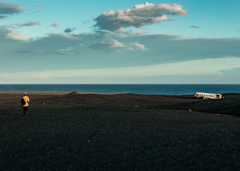 plane, outdoors, beach, dc3, water, sea, non-urban scene, horizon, iceland, cloud, horizon over water, sky, tranquility, landscape, one person, lifestyles