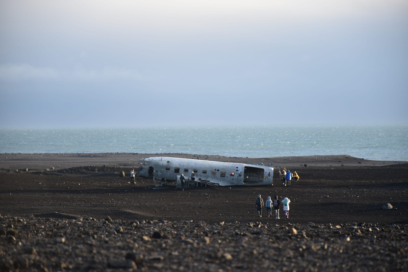 day, arrival, travel, dirt road, ground, person, aircraft, wrecked, road, landing, holiday, gravel, airfield, mode of transportation, horizon, transportation